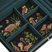 Close-up of woodland embroidery inside jewellery box featuring hedgehog, owl, squirrel, birds, flowers and mushrooms