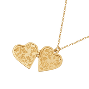 Open gold swallow heart locket showing two decorative interior compartments for photographs