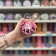 Fairies of the Shadows wax melt pot held in hand with colourful wax melt display in the background