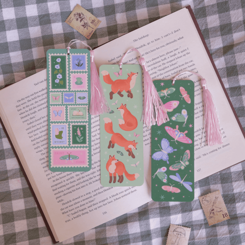 Fairycore Stamps bookmark displayed with fox and butterfly bookmarks