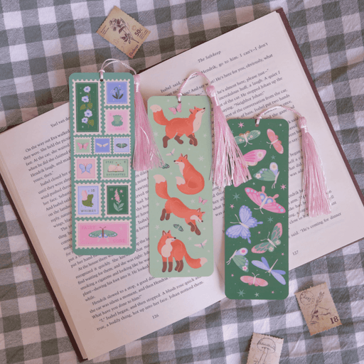 Fairycore Stamps bookmark displayed with fox and butterfly bookmarks