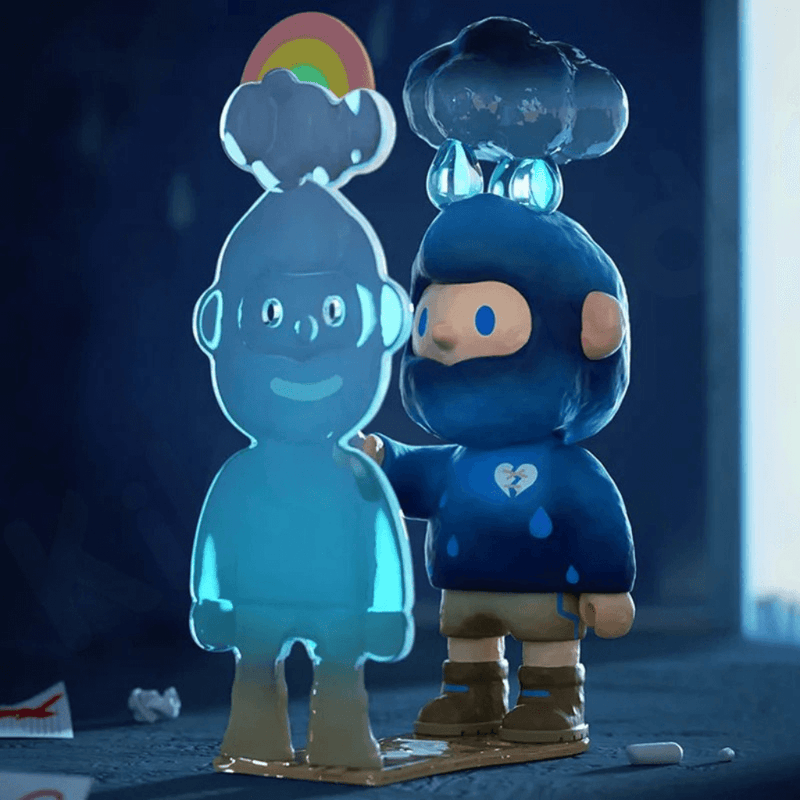 Farmer Bob Feeling You “Sad” mini in navy suit with rain-cloud hat touching rainbow silhouette.
