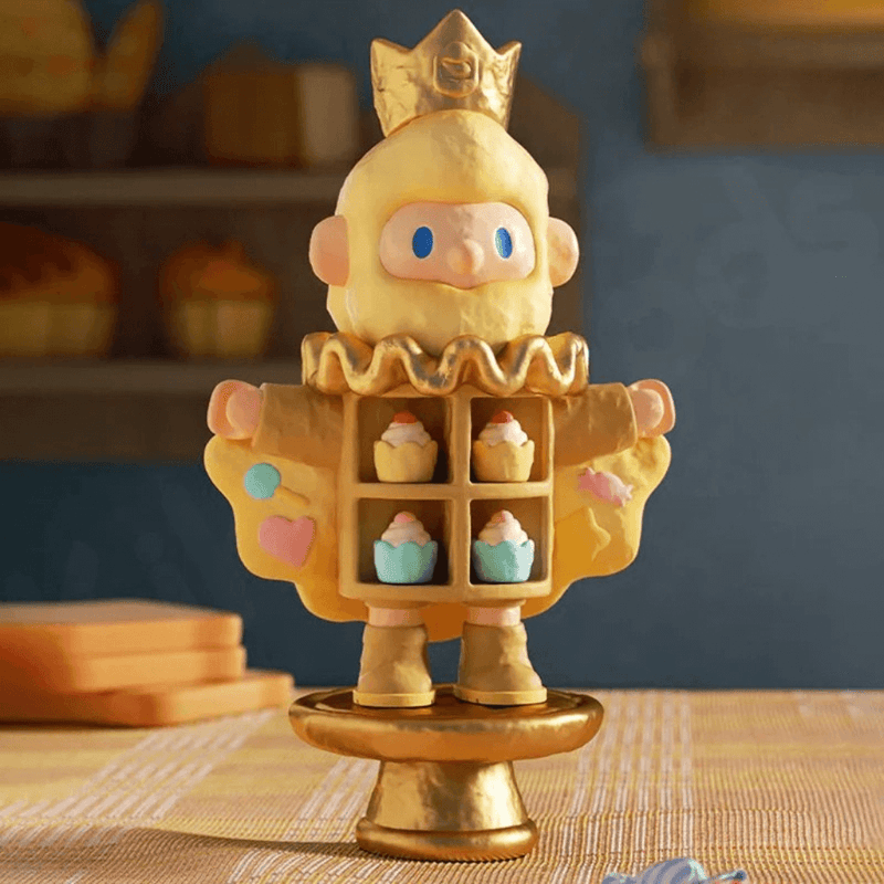 Farmer Bob Feeling You “Happy” figure with golden crown opening coat to reveal pastel cupcakes.
