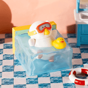 Swimmy Fatgoose wearing swimming goggles in a blue pool with a yellow rubber duck