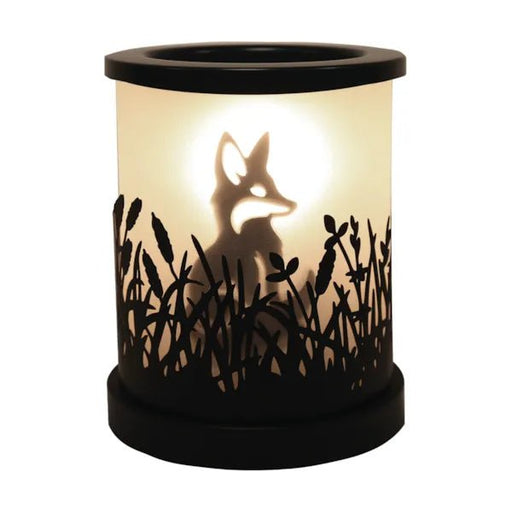 Black fox silhouette electric wax melt burner glowing warmly with meadow cut-out detailing around the base.