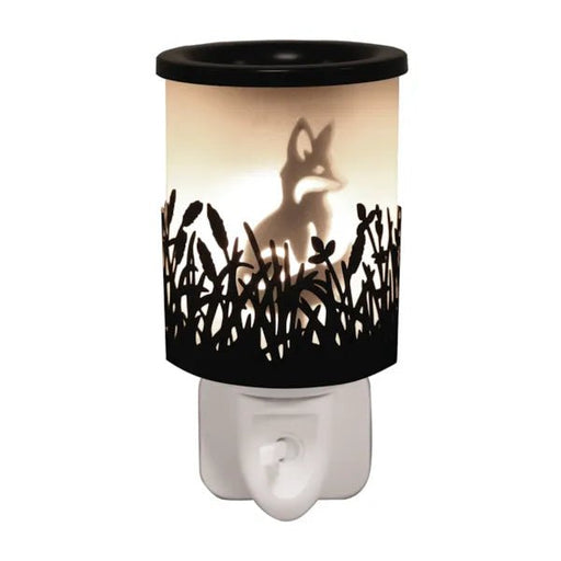 Black plug in wax melt burner glowing with a fox silhouette and cut-out grass detail, with an on/off switch on the plug base.
