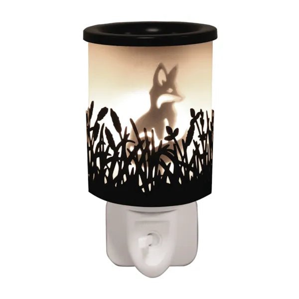 Black plug in wax melt burner glowing with a fox silhouette and cut-out grass detail, with an on/off switch on the plug base.