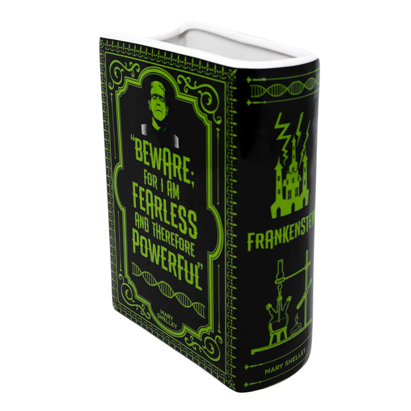 Angled view of Frankenstein ceramic book vase showing sculpted pages and white glazed interior.