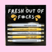 Fresh Out Of F*cks pen set on black backing card, 5 black-ink ballpoints in white and yellow with bold, sweary phrases for funny stationery gifts.