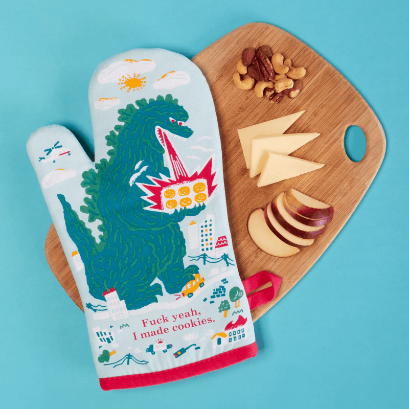 Fuck Yeah I Made Cookies oven mitt displayed on a wooden board with snacks