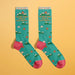 Laid flat novelty socks with hiking mountain pattern and humorous anxiety message, perfect for quirky gift-giving.

