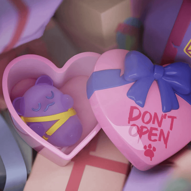 Purple Ghost Bear bound in yellow tape inside heart-shaped box labelled “DON’T OPEN”—“Alone Inside” collectable

