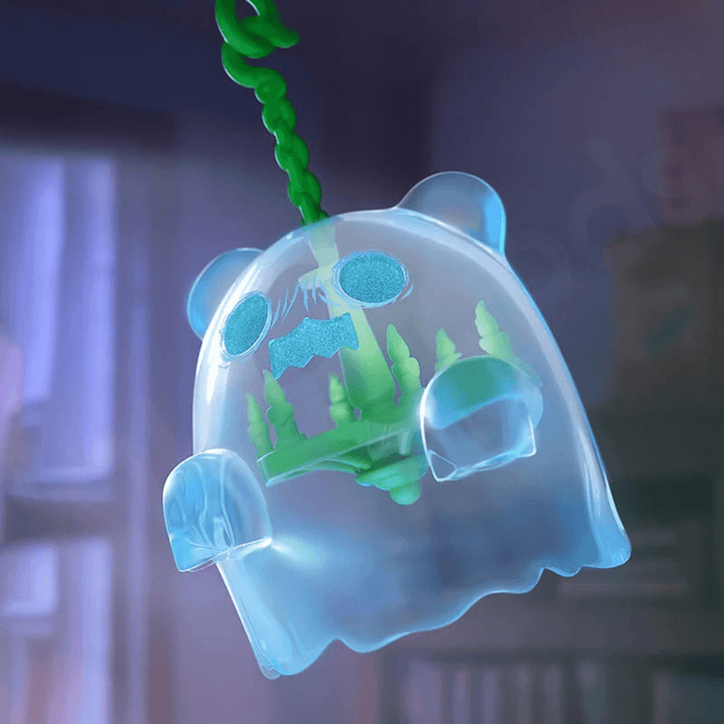 Clear hanging Ghost Bear filled with green pine trees, swinging like a car air freshener.
