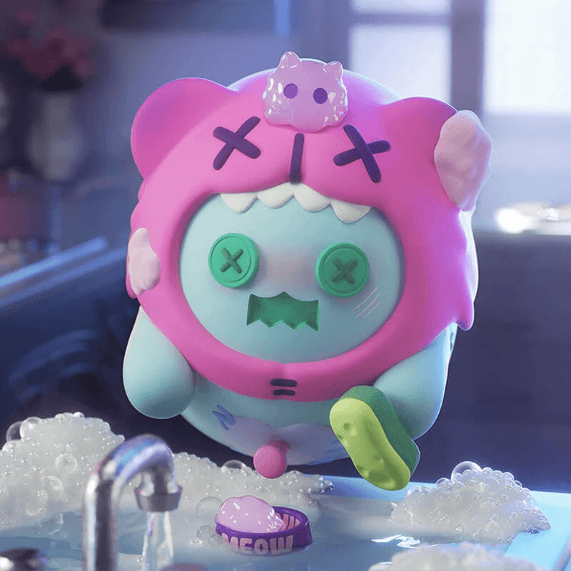 Mint Ghost Bear in pink cat hoodie scrubbing dishes among soap suds and ‘Meow’ bowl.
