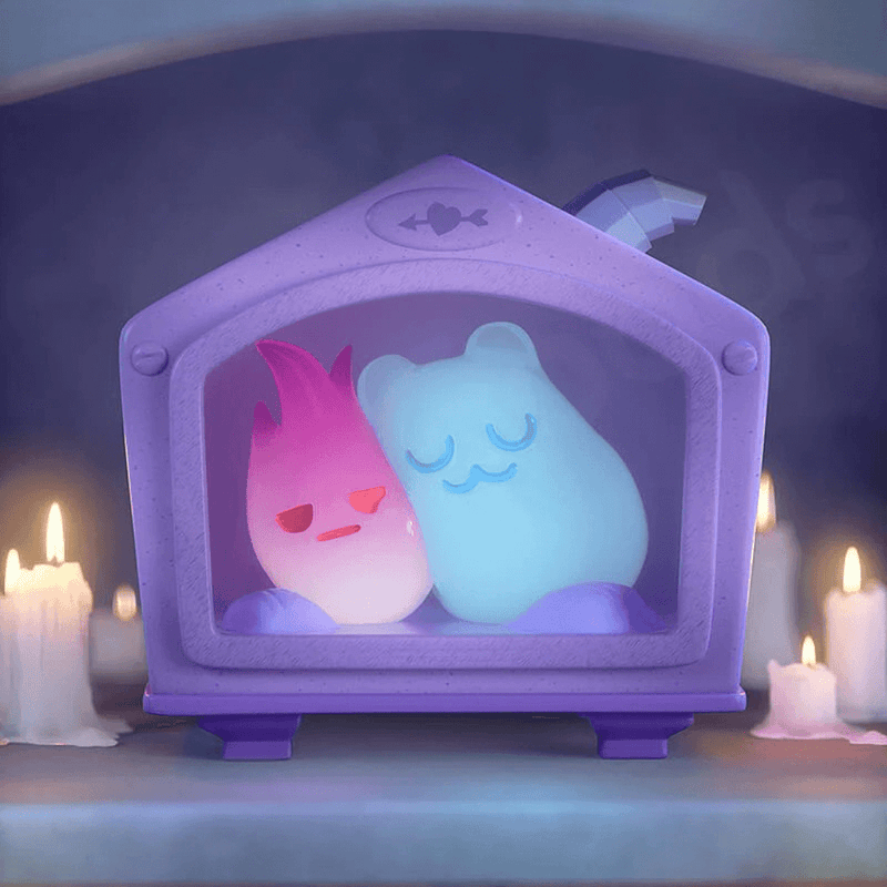 Blue Ghost Bear dozing with pink flame sprite inside purple tabletop fireplace, candles glowing.
