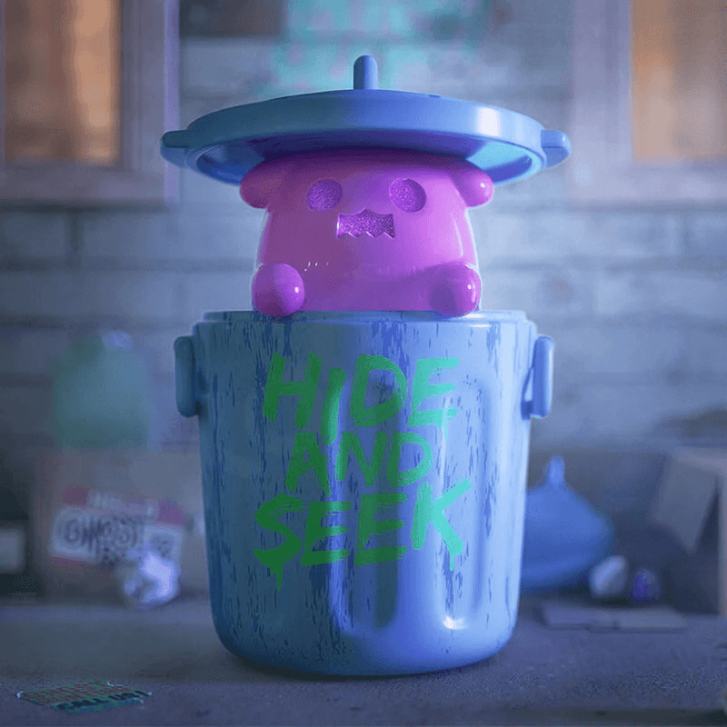 Magenta Ghost Bear pops from blue bin marked “Hide and Seek” in a dim cellar.

