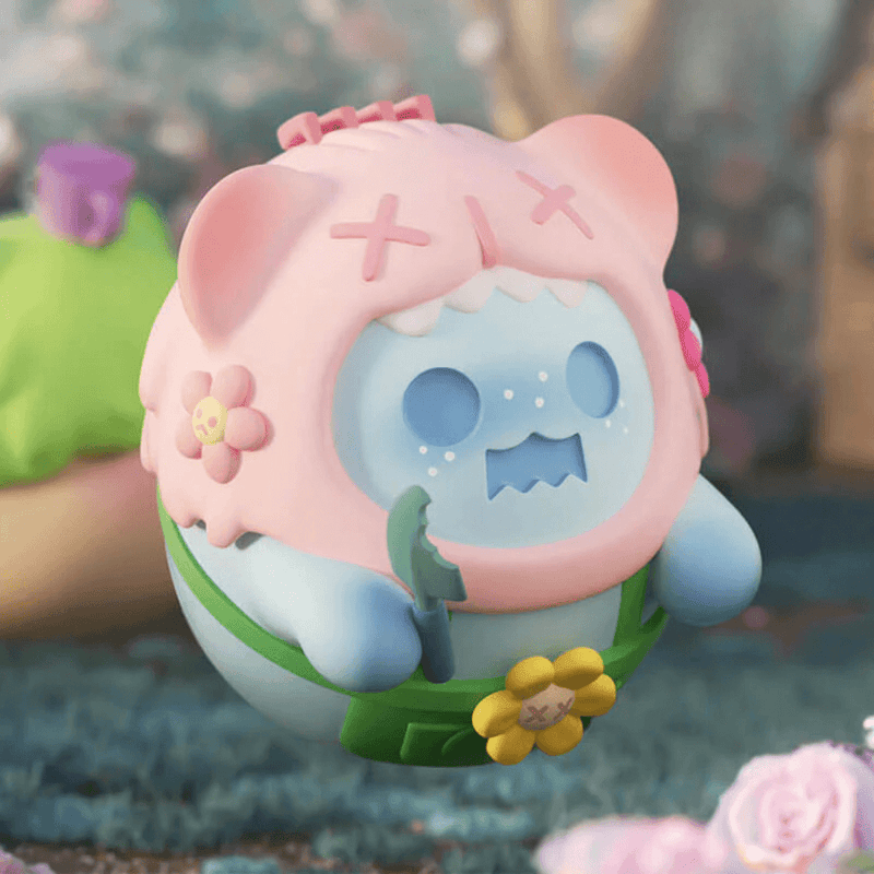 “Naughty Gardener” Baby Ghost Bear in pink hood wielding trowel and flower belt – The Secret Bear Garden figure
