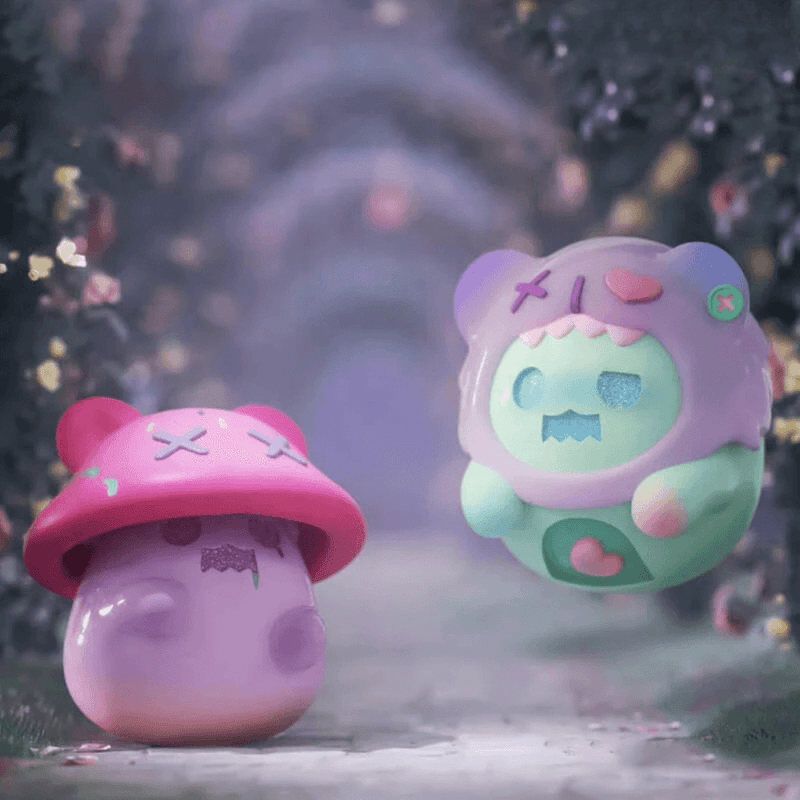 Pink “Poisonous” mushroom Ghost Bear beside mint Ghost Bear with heart emblem on garden path – Secret Bear Garden figure scene
