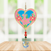 Heart-shaped Gladioli Crystal Suncatcher with pink gladiolus motif and faceted prism heart catching sunlight

