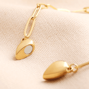 Close-up of the gold magnetic heart pendant showing the magnet detail on the side