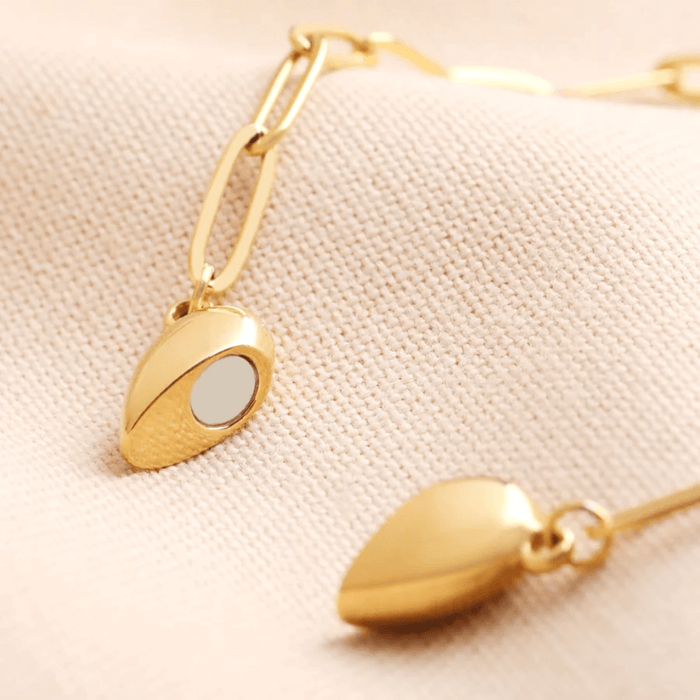 Close-up of the gold magnetic heart pendant showing the magnet detail on the side