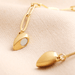 Close-up of the gold magnetic heart pendant showing the magnet detail on the side