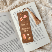 A Good Book and Bed by 9pm bookmark inside an open book