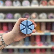 Good Girl blue segmented wax melt held in hand