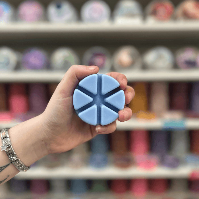 Good Girl blue segmented wax melt held in hand
