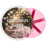 Pink Gorgeous Flora wax melt with vintage-style floral table scene featuring jasmine and pear slices.