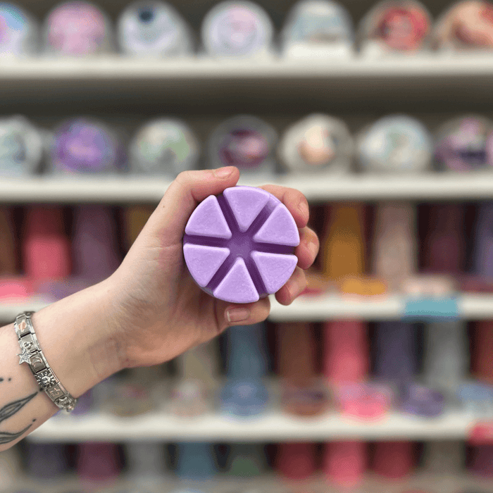 Grape Soda purple segmented wax melt held in hand