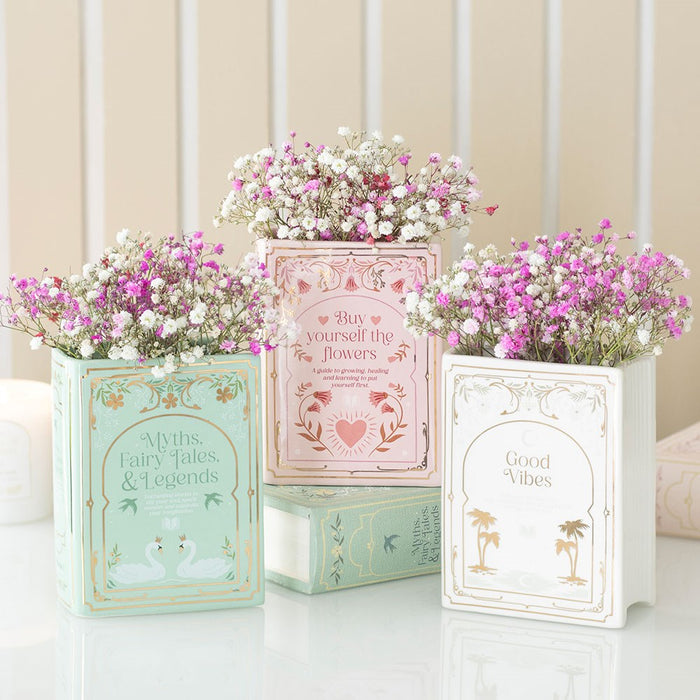 Green book vase with pink and white flowers for reading nook decor