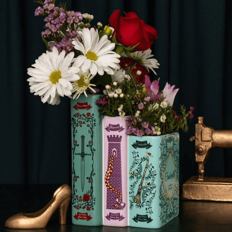 Grimm’s Fairy-Tale triple book vase styled with mixed flowers and golden shoe decor