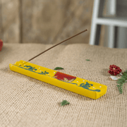 Handpainted ceramic Moon Crane incense holder with stick incense on a woven surface