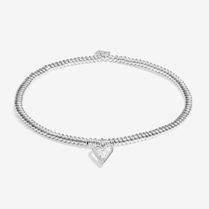 Silver beaded bracelet with pointed open‑heart diamond charm on white background