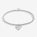 Full view of Joma Jewellery A Little Happy First Mother’s Day Bracelet, silver-plated beaded stretch Bracelet with double heart charm.