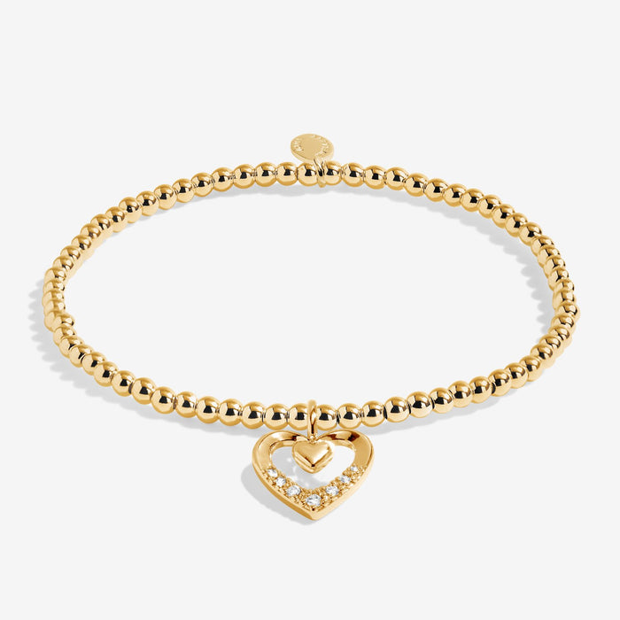 Full view of Joma Jewellery A Little Happy Mother’s Day Bracelet, gold-plated beaded stretch Bracelet with heart charm and crystal detail.