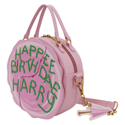 Angled view of Loungefly Happee Birthdae Harry Cake Crossbody Bag with umbrella charm