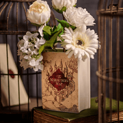 Harry Potter Marauder’s Map ceramic book shaped vase displayed with white flowers