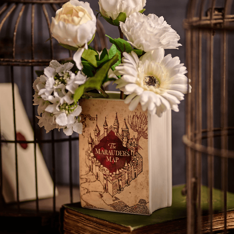 Harry Potter Marauder’s Map ceramic book shaped vase displayed with white flowers