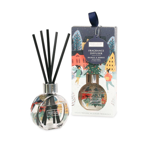 Heart & Home Baubles & Berries reed diffuser in a round bauble-shaped glass with black reeds beside the illustrated gift box with ribbon tag.