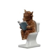 Highland cow reading a book while seated on a toilet, 15cm hand-painted resin figurine, white background.