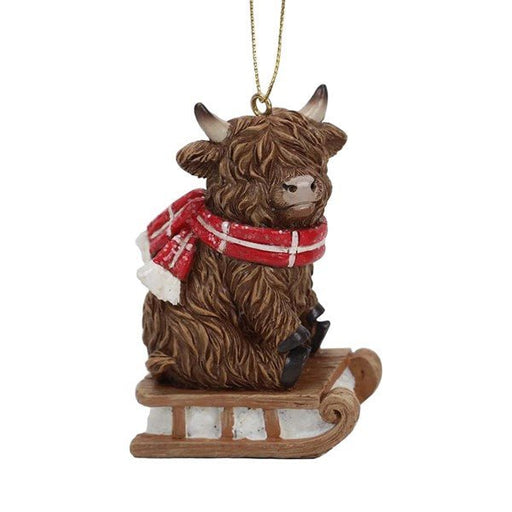 Highland cow on wooden sledge with red scarf, 9cm Christmas tree decoration.

