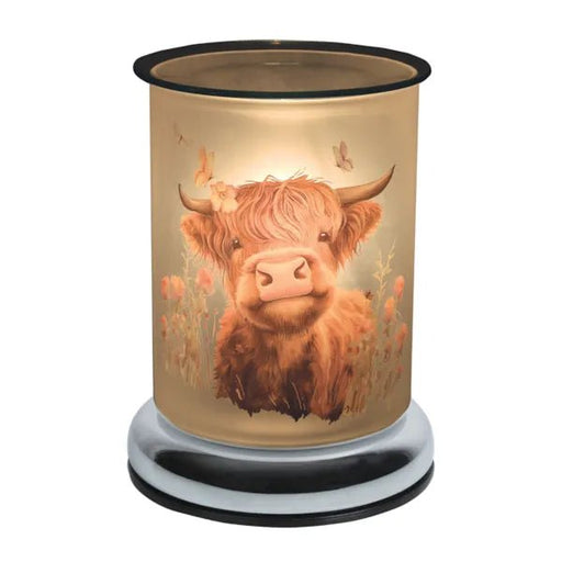 Highland cow touch wax melt burner switched on, glowing warmly through the illustrated glass design.
