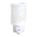 White plug in wax melt burner unlit, showing the cut-out grass design and frosted panel with the Highland cow silhouette behind.