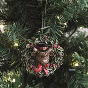 Highland Cow wreath ornament hanging on a lit Christmas tree, 8cm.

