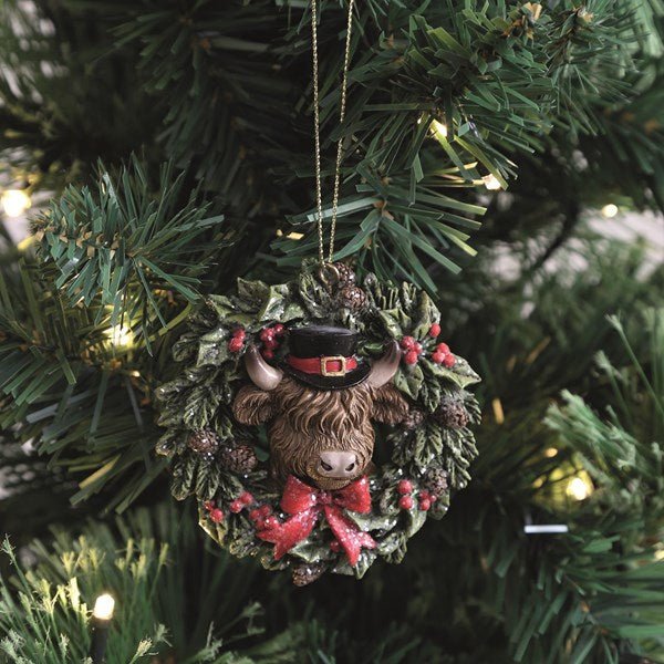 Highland Cow wreath ornament hanging on a lit Christmas tree, 8cm.

