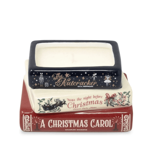 Front of Holiday Classics ceramic scented candle featuring navy, cream and red spines of three classic Christmas stories