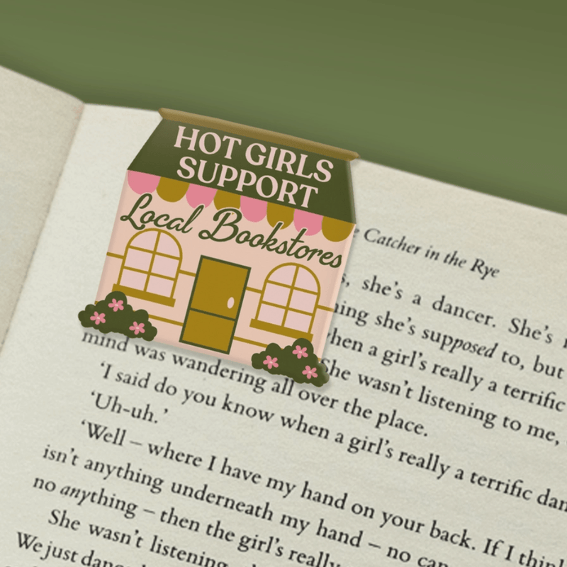 Hot Girls Support Local Bookstores magnetic bookmark marking a page in a book