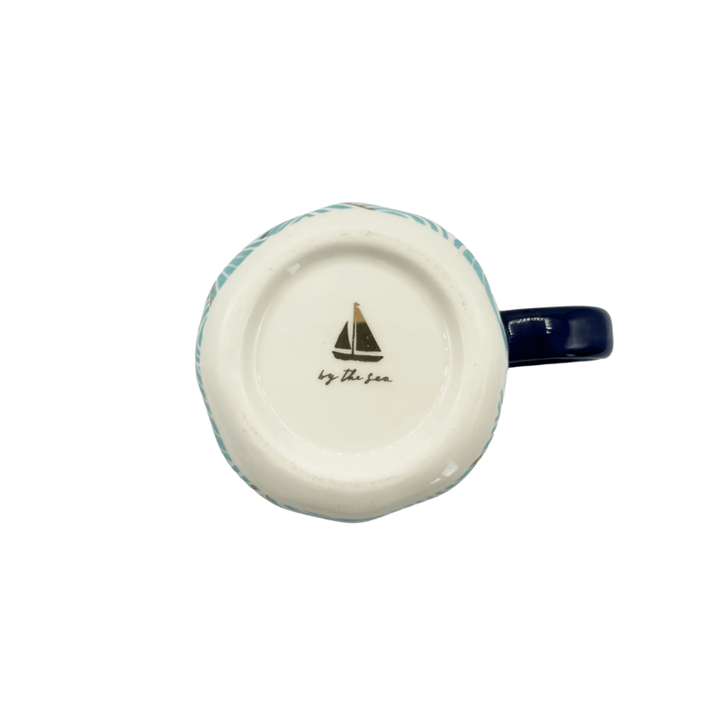 Base of the By The Sea cup showing the sailboat mark and branding underneath